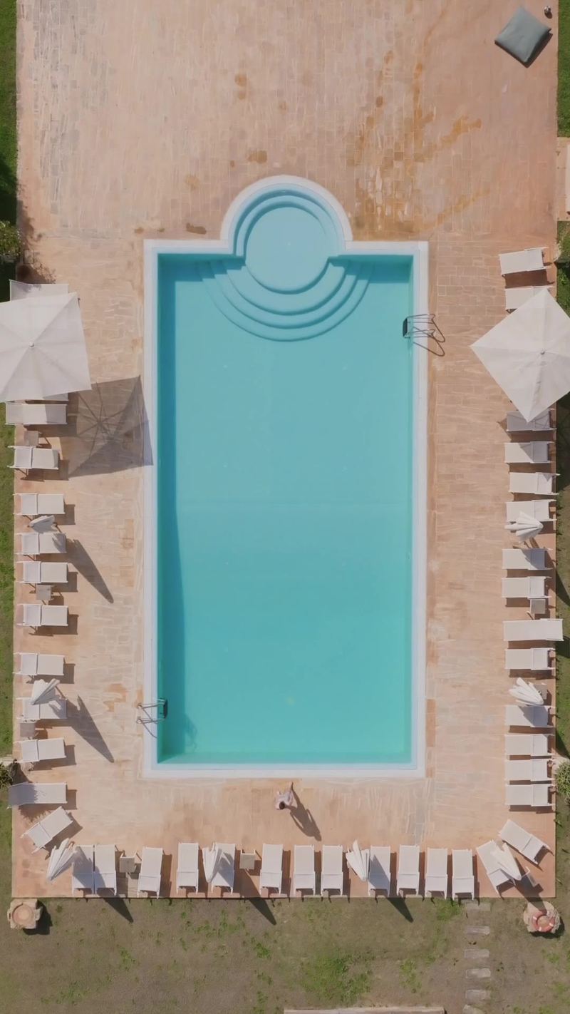 Aerial view of a backyard pool behind a house