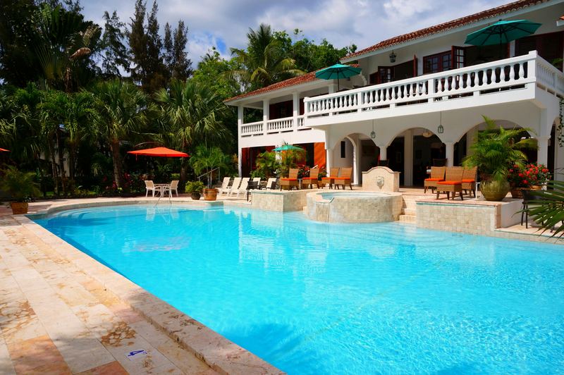 Backyard pool behind a family home
